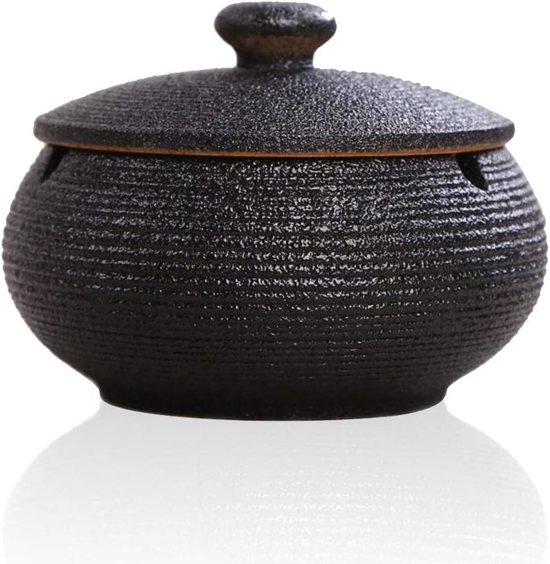 Lependor Black Ceramic Ashtray with windproof lid, displayed on a table, ideal for indoor or outdoor smoking, home, or office decoration.