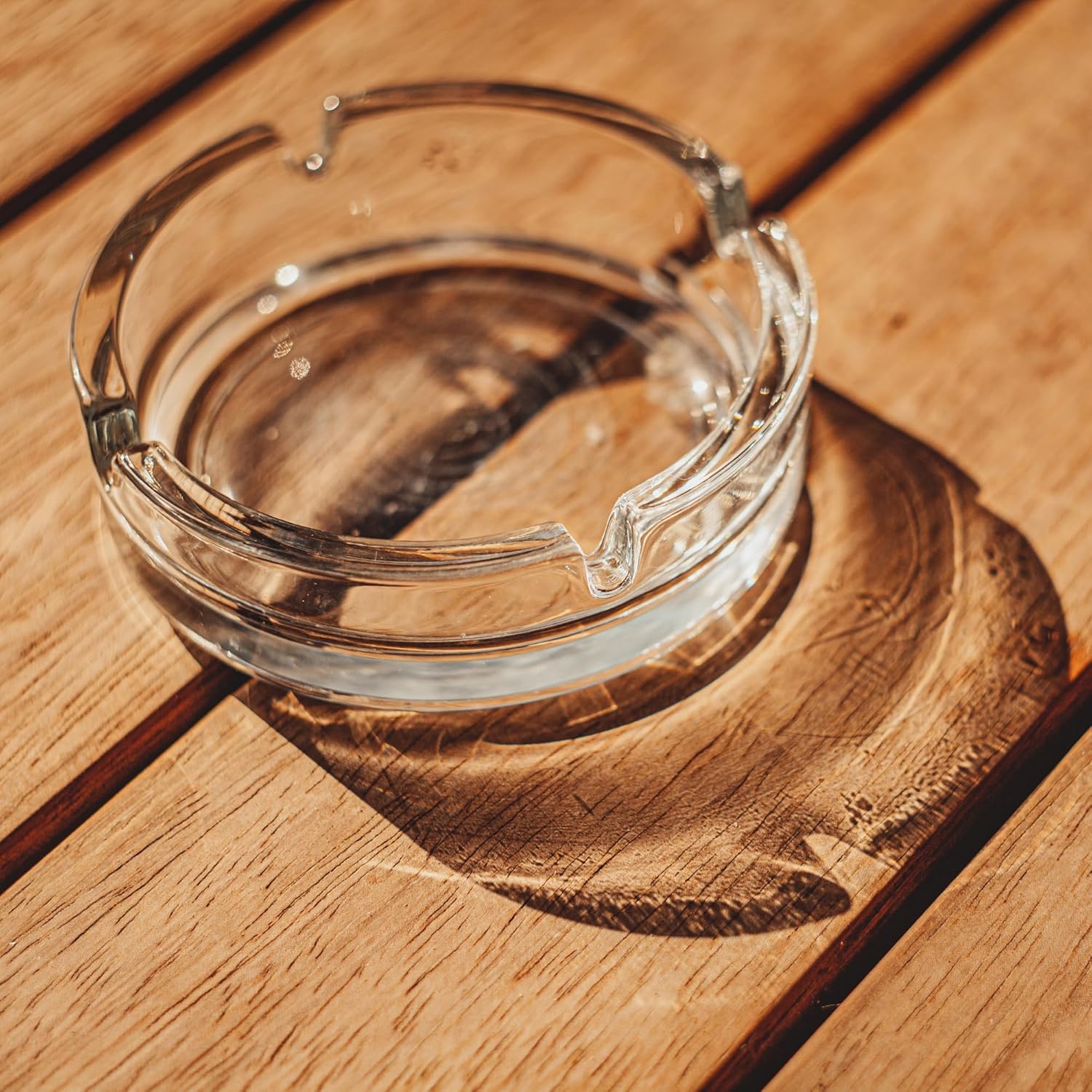 Set of 2 Round Glass Ashtrays, clear and stylish, displayed on a table, ideal for home, garden, bar, or pub use in smoking accessory collection. 
